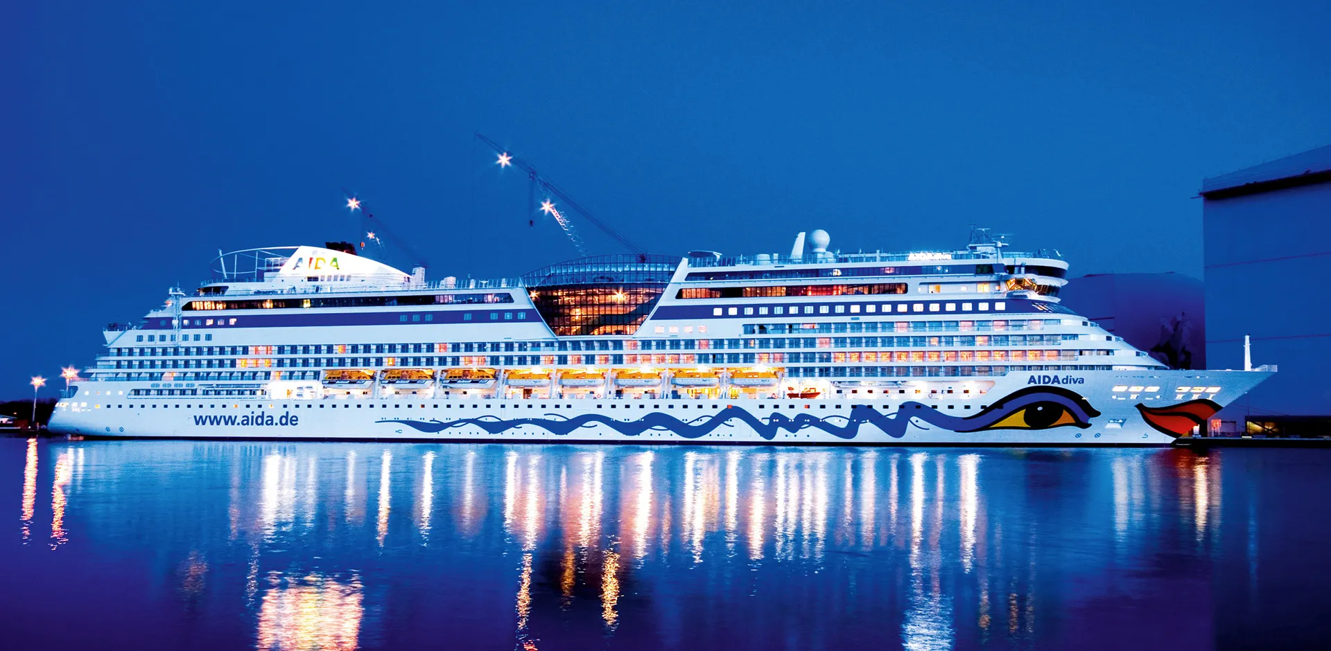 A cruise ship moored in port at night